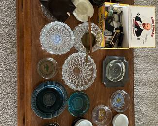 variety of vintage ashtrays and old lighters