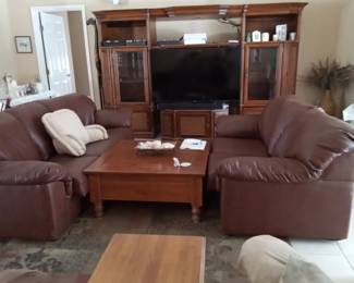 2 leather couches, entertainment center and large Vizio tv