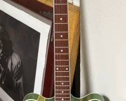One of 3 Ibanez electric guitars, 2 blue, 1 green