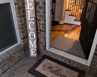 Outdoor welcome sign and mat
