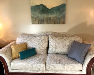 White Upholstered Sofa With Demasque Style Pattern And Wooden Accents