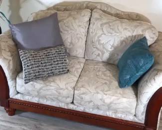 White Upholstered Sofa With Demasque Style Pattern And Wood Accents Accent Table And Decor