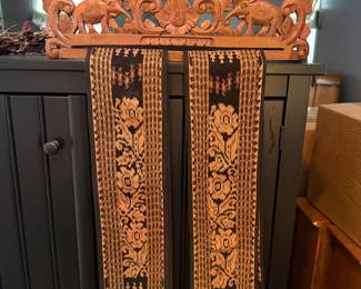carved wood elephant and fabric wall art