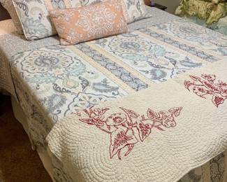 queen bed and upholstered headboard--notice the sweet embroidered quilt