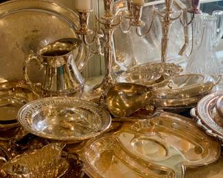 Silverplate serving pieces including candleabras, platters, meat trays, pitchers