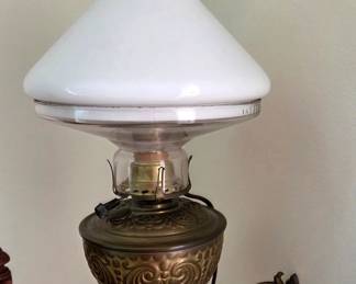 Antique wall oil lamp converted to electric.