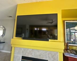 Flat screen TV with soundbar.