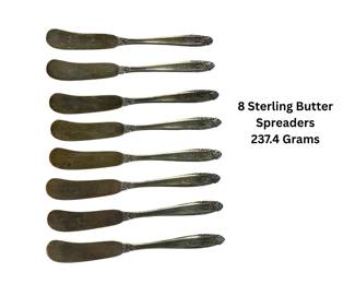 Eight vintage flat-handle butter spreaders