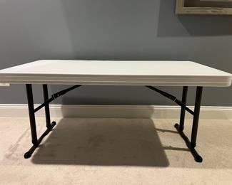Adjustable height table. Collapsible. 30” width x 72” length. Height: 25”-35” (several heights between as well).