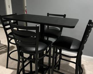 Black High table and 4 cushioned chairs with backings. Perfect condition.