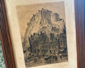 The artwork captures a classic 19th-century view of Edinburgh Castle looming high above the bustling streets and shops of the historic Grassmarket.