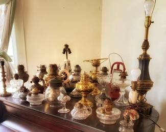 This beautiful group of antique kerosene and oil lamps includes a mix of 19th and early 20th-century styles, with everything from charming mini brass lamps to classic glass chimney lamps. These timeless pieces look just as good displayed today as they did over a century ago.