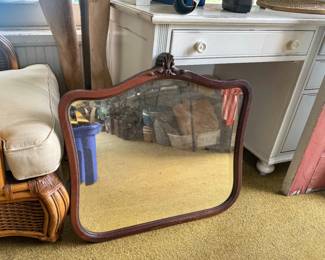 Enhance your home decor with this beautiful vintage mirror. It features a rich, dark wood frame with a classic wavy, arched top and rounded bottom corners.