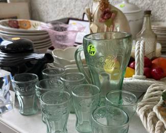 Add a splash of vintage charm to your home bar or kitchen with this beautiful, light green glass Coca-Cola set! 