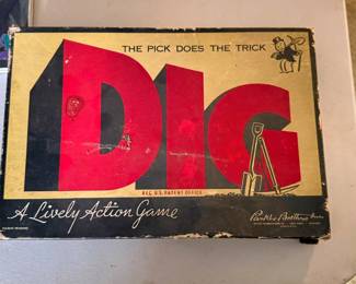 This is a rare 1940 edition of "DIG: A Lively Action Game" published by Parker Brothers. It features iconic early artwork including Rich Uncle Pennybags (the Monopoly Man) wielding a pickaxe in the upper corner