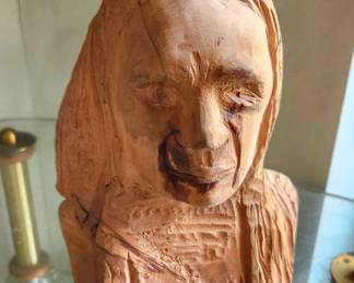 This hand-carved wooden bust is a beautiful example of folk art, where every chisel mark tells part of the story. The artist embraced the natural grain and warm tones of the wood, creating a rustic, organic sculpture full of character.
