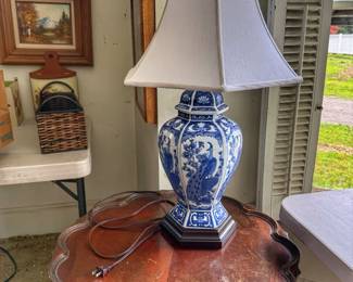 Add a touch of classic elegance to your home with this beautiful vintage ginger jar style table lamp. The porcelain base features a stunning, highly detailed blue and white scene showcasing a peacock nestled among floral branches and traditional patterns.