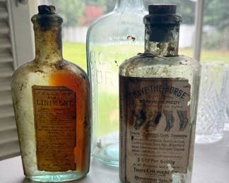 Add a fascinating piece of history to your collection with this lot of three authentic, turn-of-the-century glass apothecary bottles. 
