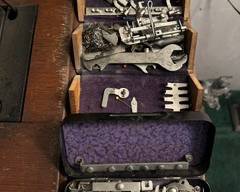 Antique sewing machine with attachments and manuals