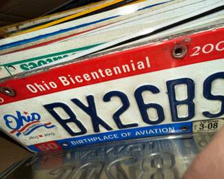 Pile of older license plates from all over