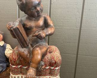 Antique wooden cherub 1870.  French, hand carved from limewood- seated on a tufted miniature ottoman made of antique paisley shaw