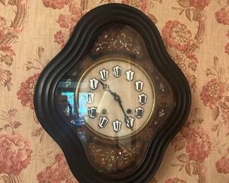 French antique clock adorned in mother of pearl and marble