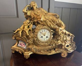19th century French clock hand painted with bronze finish and candelabra   2’L by 9”  It’s history: It was rescued from a hurricane in Europe. The clock does not work