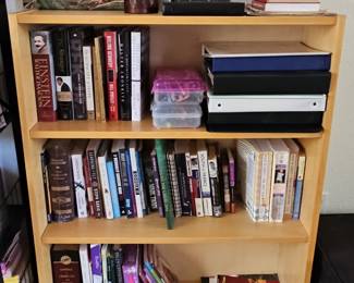 Assorted Books and Collectibles on a Folding Wooden Bookshelf