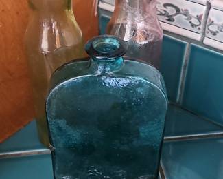 Collection of Three Antique Glass Bottles: Teal Flask and Amber/Purple Vases