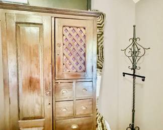 Wood armoire filled with yes more clothes and more jewelry