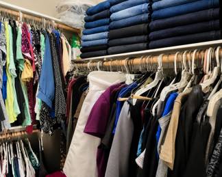Closets of jeans, sweaters, dresses