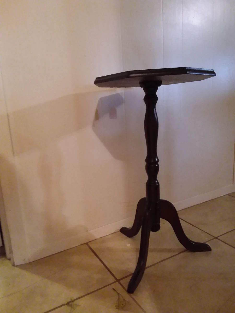 Adorable three legged wooden vintage table. Makes a