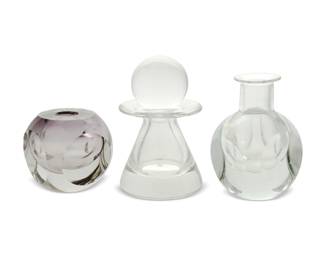 2048 Three Val St. Lambert glass table items Mid/late 20th century One with acid-etched signature to underside: Val St Lambert / A Collard [Alfred Collard]; one with acid-etched signature, title, and edition: Val St Lambert / [sic] / 16.06.87 / 85/500 Comprising one geometric-form vase with spherical interior cavity and flared neck, one conformingly designed vase, and one conical vase with flared neck and a spherical stopper 3 pieces Largest: 10.325" H x 6.25" Dia.; Smallest: 5.875" H x 6" W x 6" D Estimate: $300 - $500