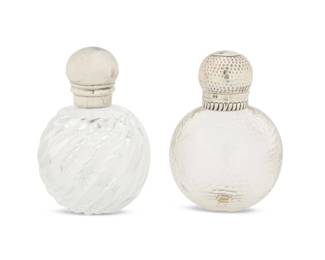 2040 Two Victorian glass and sterling silver perfume bottles Late 19th century Each lid marked for sterling; the hammered top marked for Chester, 1894, and maker: WA [William Aitken]; smooth marked for London, 1886, and: ASPREY BOND ST; possibly also reading: RTB [Robert Thomas Baker] 2 pieces Hammered: 4.25" H x 3" Dia.; Smooth: 4.375" H x 2.875" Dia. Estimate: $300 - $500