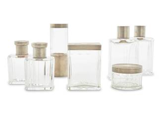 2047 An assembled vanity set Early/mid-20th century Five pieces monogrammed 'GD' Each glass, electroplated silver, and vermeil, comprising four scent bottles and three covered jars 7 pieces Tallest: 5.125" H Estimate: $100 - $200