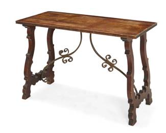 2154 A Spanish Baroque style fratino table 20th century Carved wood, raised on lyre-form legs and feet joined by wrought-iron curvilinear stretchers 29.5" H x 43.5" W x 19.75" D Estimate: $600 - $800