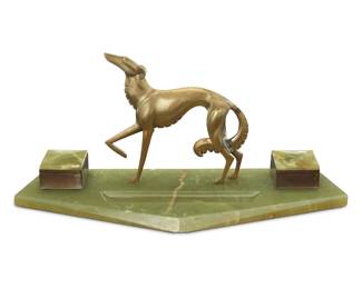 2178 An Art Deco bronze and onyx figural encrier Circa 1925 With a bronze greyhound figure mounted to an onyx base with two inkwells Overall: 8.5" H x 19.5" W x 6.875" D Estimate: $300 - $500