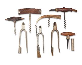 2161 A group of bottle openers Late 19th/early 20th century One antler marked to end cap for sterling and for Gorham; another marked: 925 Comprising three Victorian English champagne pliers, one cork puller with carved wood handle, two corkscrews with carved wood handle, and two corkscrews with carved antler handles, two mounted with sterling silver, one monogrammed 8 pieces Largest corkscrew: 5.5" H x 5.25" W; Pliers: 6.5" L approx. Estimate: $200 - $400