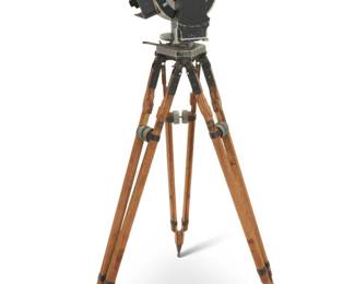 2239 An Akeley Cine 35mm camera Circa 1920 Numbered twice: 157 Metal, glass and wood, the adjustable telescope viewfinder enabled cameraman to follow rapid action regardless of tilt of camera, with an 18 x 24 mm image size, raised on a wood and metal tripod Tripod stored: 46.25" H x 8.75" W x 8.75" D; Camera: 16.25" H x 16" W x 9.5" D, dimensions variable Estimate: $600 - $800