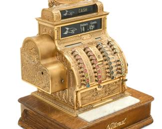 2238 A National cash register model 441 Circa 1910-1915 Marked to metal plaque: NATIONAL CASH REGISTER CO. / DAYTON, OHIO, U.S.A.; numbered: 1513184 / 441 Brass case on marble above a wood cash till 28" H x 17" W x 20.5" D Estimate: $300 - $500