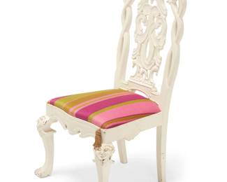 2027 A Dutch Rococo style side chair 20th century The white painted carved wood frame with openwork seatback featuring bird-form figural and scrolled motifs, above a later fabric upholstered seat cushion with tassel, raised on four legs, the front two displaying upper masks in relief and paw feet 42.25" H x 24.5" W x 22.5" D Estimate: $100 - $200