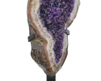2150 An amethyst geode specimen 20th century On a metal stand Geode: 12" H x 7" W x 4" D; Stand: 8.5" H x 5.75" W x 4" D Estimate: $300 - $500