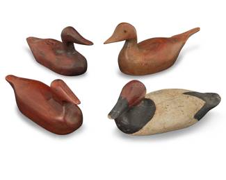 2147 Four carved wood duck decoys 20th century One painted black and white 4 pieces Largest: 7.375" H x 20.75" W x 6" D; Smallest: 5.5" H x 12.375" W x 3.75" D Estimate: $200 - $300
