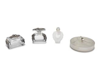 2041 A group of art glass vanity items 20th Century One signed: Verlys; one signed: Bottle Made by Lalique France / Coeur Joie / Nina Ricci Comprising a clear and frosted glass Verlys powder box with butterflies, a clear glass perfume bottle and lidded box with black tinted floral designs, and a clear and frosted glass Lalique "Coeur Joie" for Nina Ricci heart-shaped perfume bottle 4 pieces Larger: 4.25" H x 4.25" W x 1.75" D; Smaller: 3" H x 5" W x 2.875" D Estimate: $200 - $400