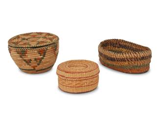 2035 Three Native American basketry items Mid/late 20th century Comprising a possibly Paiute polychrome lidded basket, a twined Northwest Coast lidded basket, and a polychrome oval pine needle basket 3 pieces Tallest: 4.125" H x 6.625" Dia.; Shortest: 2.5" H x 5" Dia. Estimate: $50 - $100