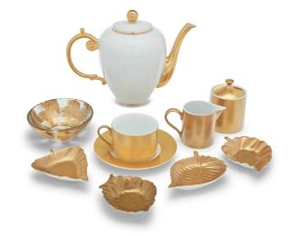 2045 A Marc Blackwell porcelain 'Florentine' tea service Late 20th century Each with printed factory marks Comprising: Marc Blackwell 'Florentine': 16 teacups (2.375" H) 16 saucers (6.25") 2 sugars (4.25" H) 2 creamers (3" H) 4 pairs of leaf-form dishes (largest: 5" W x 4.125" D) Objet 'Agean': 2 teapots (7.75" H x 10.375" W x 5.375" D) together with 1 gold overpainted footed bowl (5.125") 47 pieces Estimate: $200 - $300
