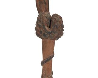 2144 A Folk Art wood carving of an eagle and snake 19th/20th century The partially painted carving depicting an eagle perched atop a tree or bush with an approaching snake coiled around 27.125" H x 7.25" W x 5" D Estimate: $200 - $400