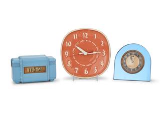 2181 Three Modern clocks Mid-20th century Lawson with applied factory label; GE impressed in the ceramic verso: Designed by Russel Wright; Telechron with impressed factory marks verso Comprising a blue Bakelite Lawson Electric clock Model P-40, a ceramic General Electric Model 2HA48 wall clock designed by Russel Wright (1907-1976), and a Telechron Electric table clock Model 4f55, electrified 3 pieces Bakelite: 4" H x 6.75" W x 3.125" D; Wright: 8" H x 8" W x 3" D Estimate: $200 - $400
