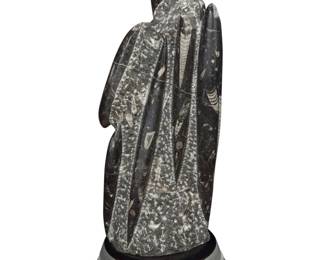 2151 An orthoceras fossil specimen 20th century; Morocco The squid fossil raised on a custom billet aluminum plinth Specimen: 17" H x 7" W x 6" D; Overall: 19.5" H x 8.125" Dia. Estimate: $200 - $300