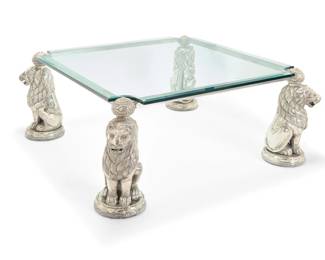 2196 A silvered metal and glass coffee table 20th century The beveled glass set on a silver-toned metal frame with lion-form supports with glass eyes Base: 22" H x 49" W x 49" D; Glass: 0.625" H x 43" W x 43" D Estimate: $500 - $700